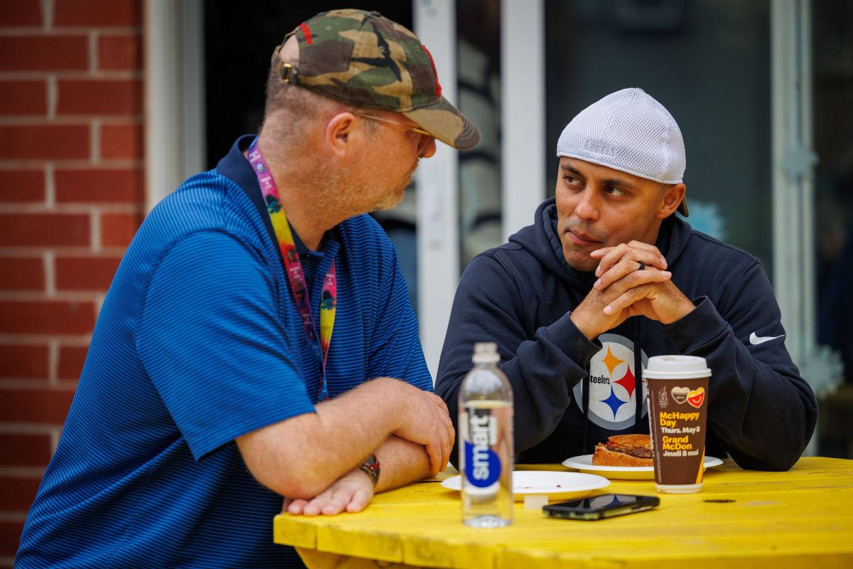 SHOW Resident Adrian (L) enjoys lunch with his support worker, Iosko (R)